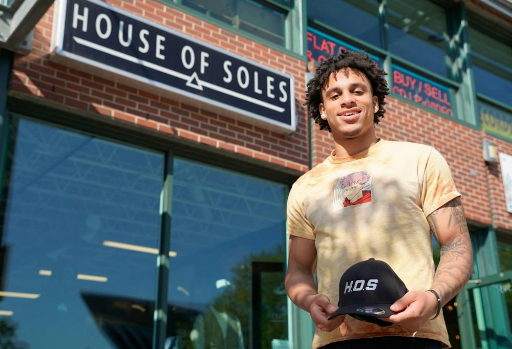 Lonnie Smith smiling outside his House of Soles storefront